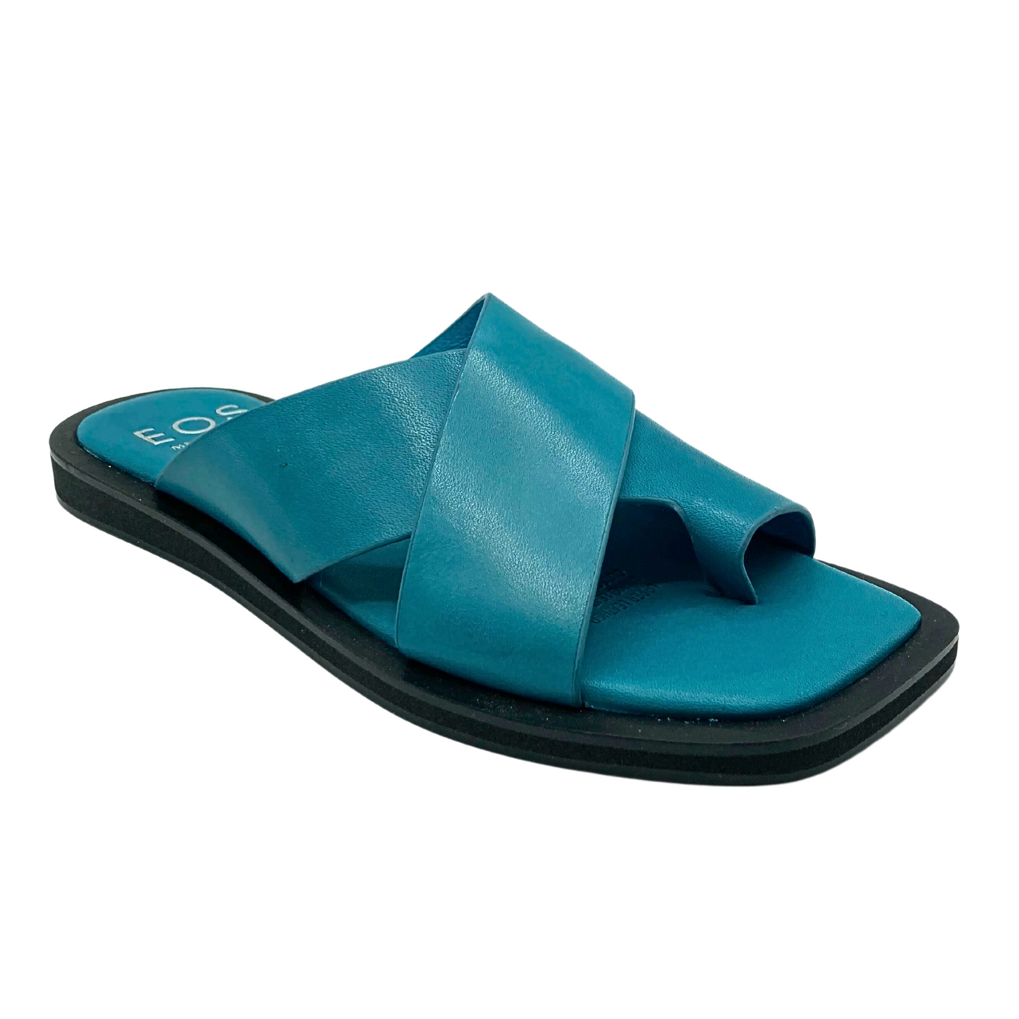 Angled side view of a blue sandal. Flat with a black sole. Cross straps and toe loop