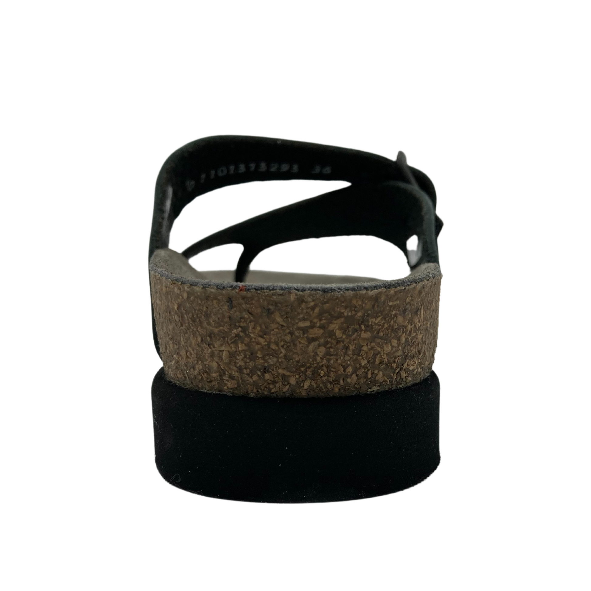 Rear view of the right sandal. Black sole and a cork footbed layered on top.