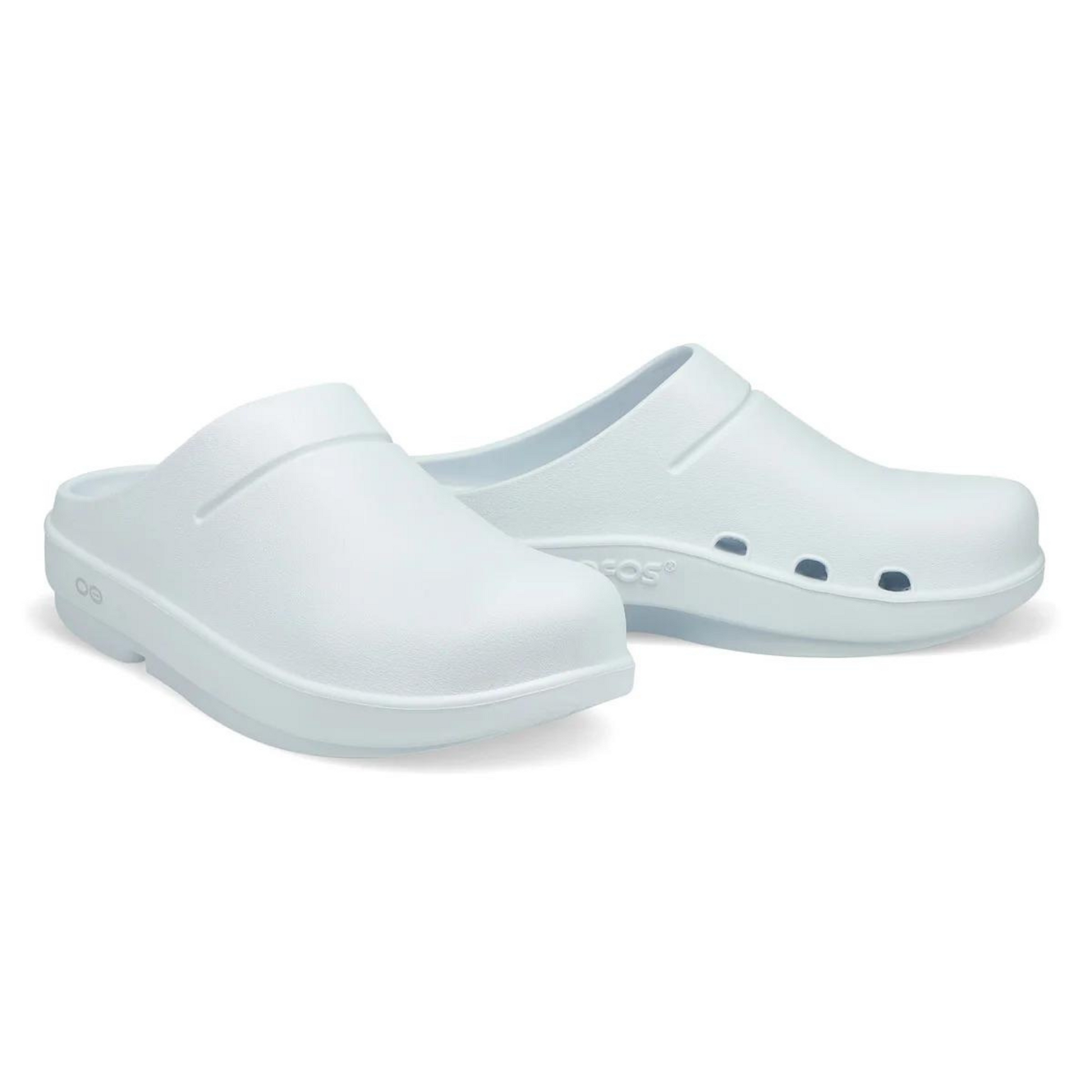 A photo of a pair of the matte white clogs, showing the holes on the inner arch of the shoe.