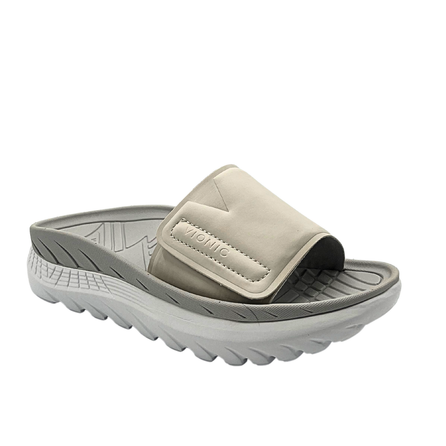 Angled side view of a water friendly beachslide with a contoured footbed and great arch support. Shown in a taupe/grey color