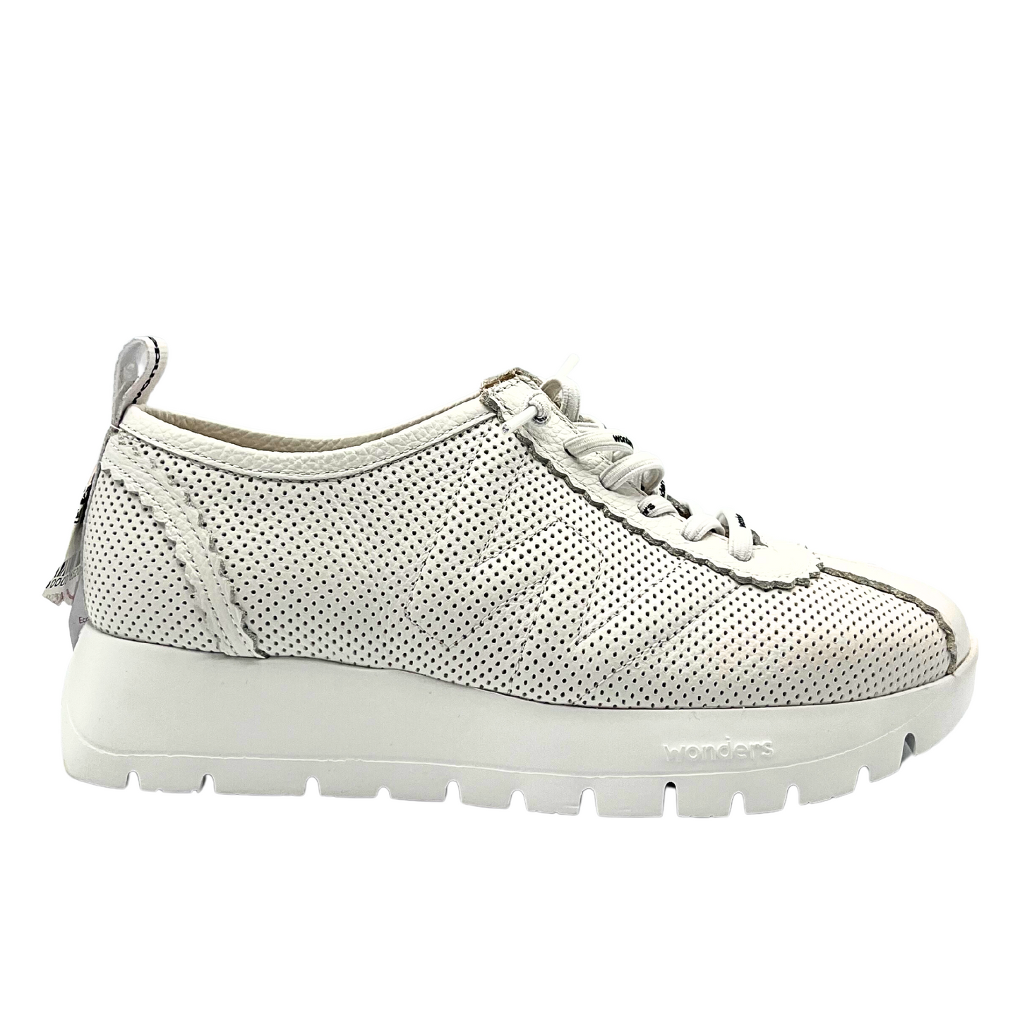 Outside view of white fashion sneaker. Details include laser cut outs in the leather