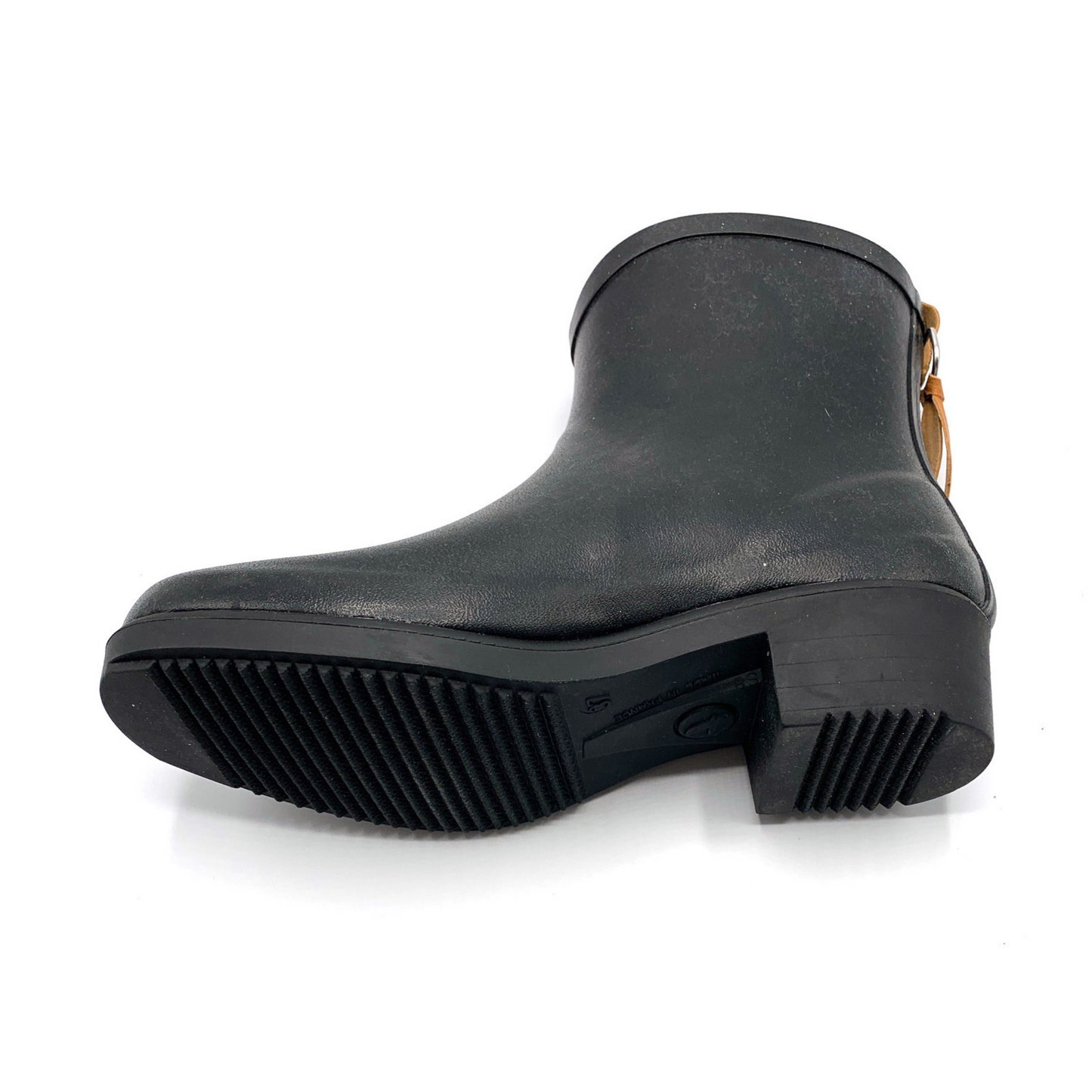 The underpart of the outsole is visible, showing rows of groves on both the ball-toe area of the boot as well as the heel.