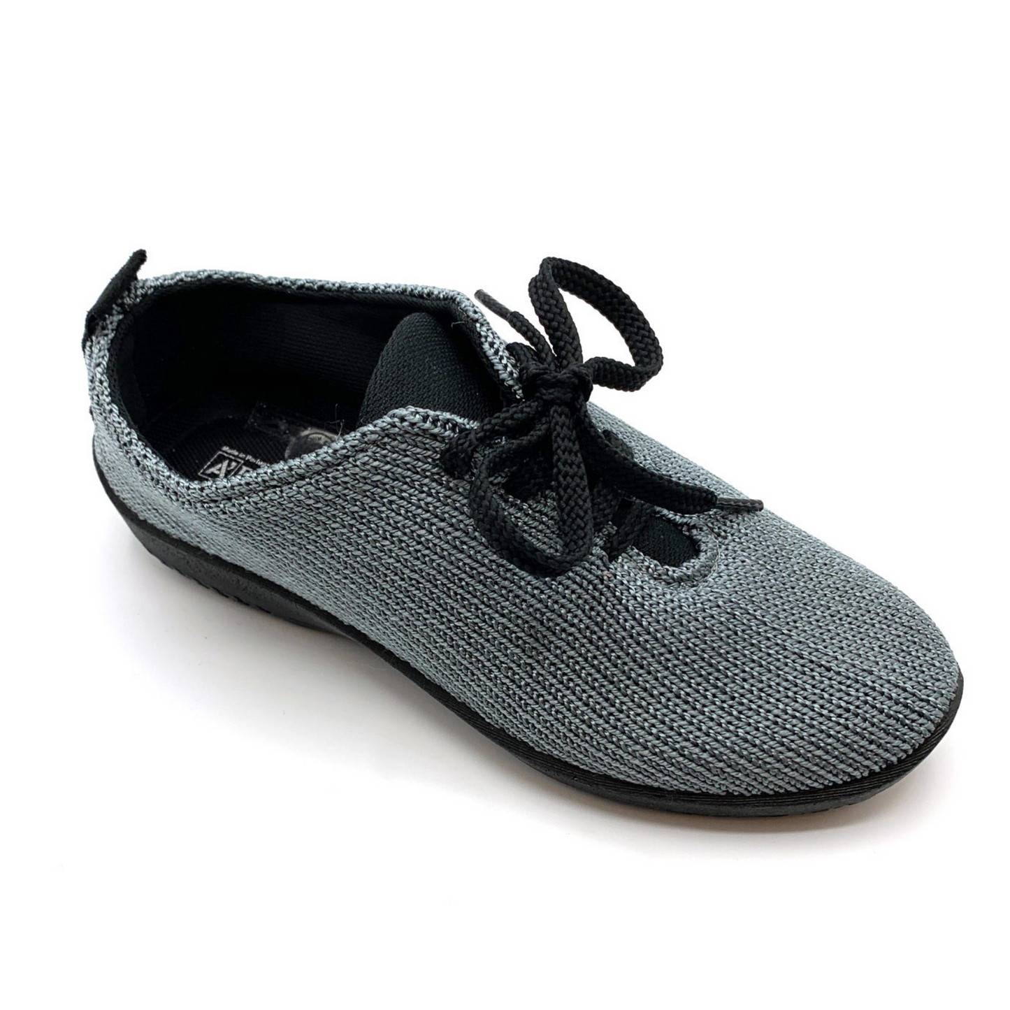 Grey knit sneaker with black lace up strings and black tongue/interior lining pictured at an angle.