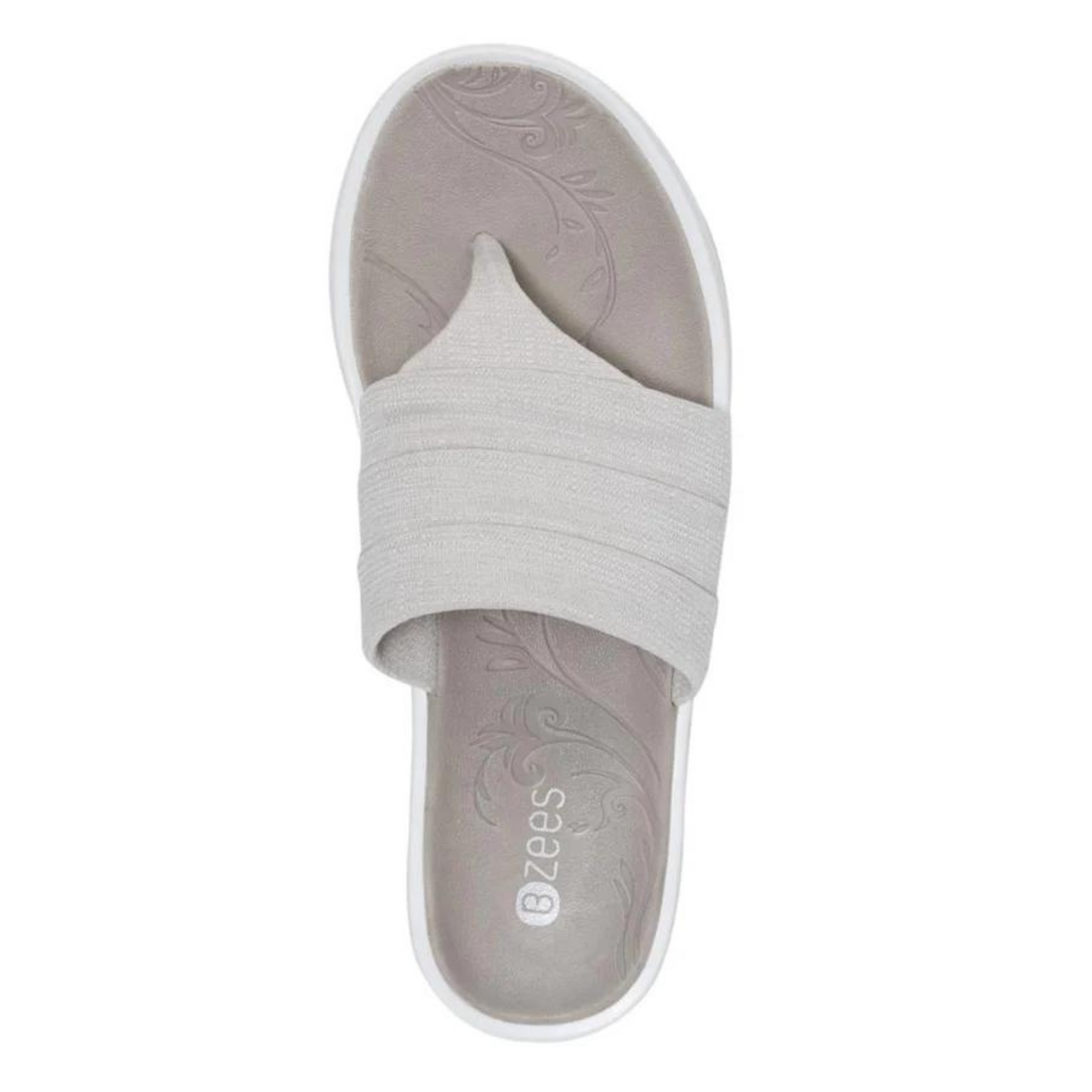 The top of a Y strap sandal is pictured featuring a grey footbed with engraved floral design.