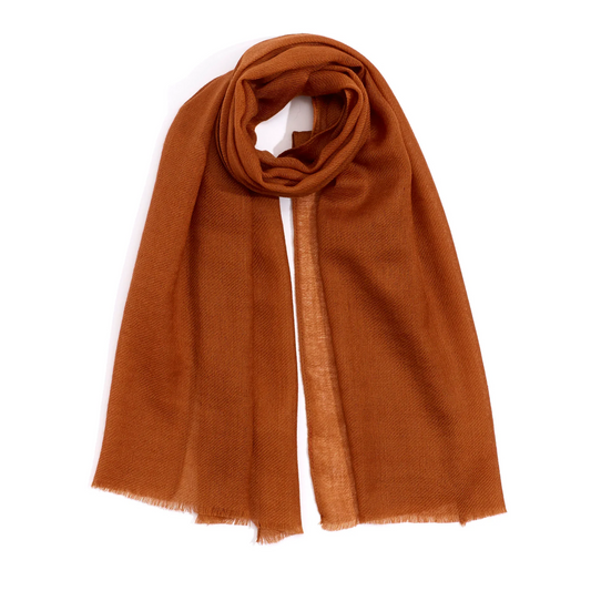 A translucent burnt orange scarf is pictured with a posed loop at the top and has a natural edge at the bottom.