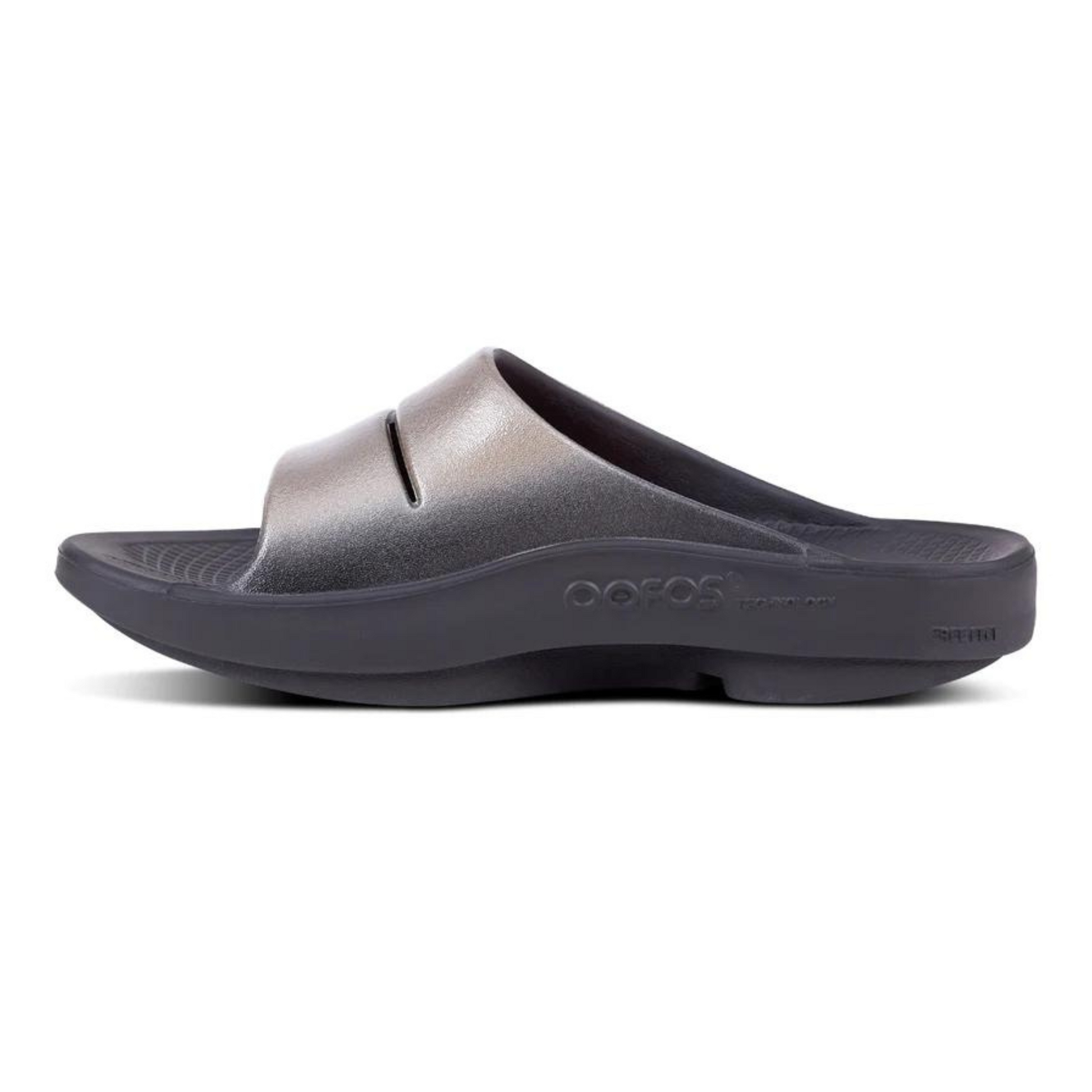 A left side view of a black slide with a shiny light coloured upper.