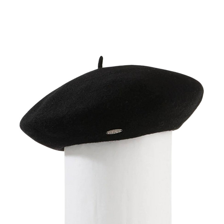 A black wool beret on a white pillar