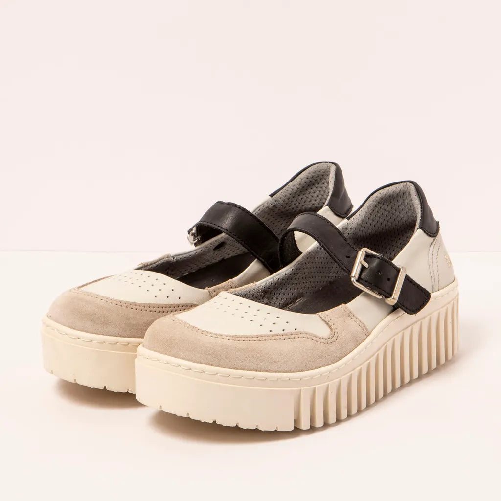 Pair of beige platform shoes with black straps on a light background