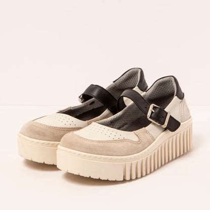 Pair of beige platform shoes with black straps on a light background