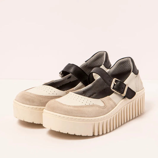 Pair of beige platform shoes with black straps on a light background