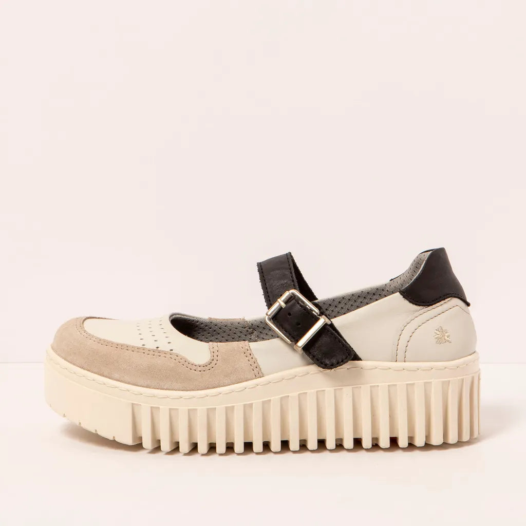 Beige platform sneaeker with a black buckle on a light beige background