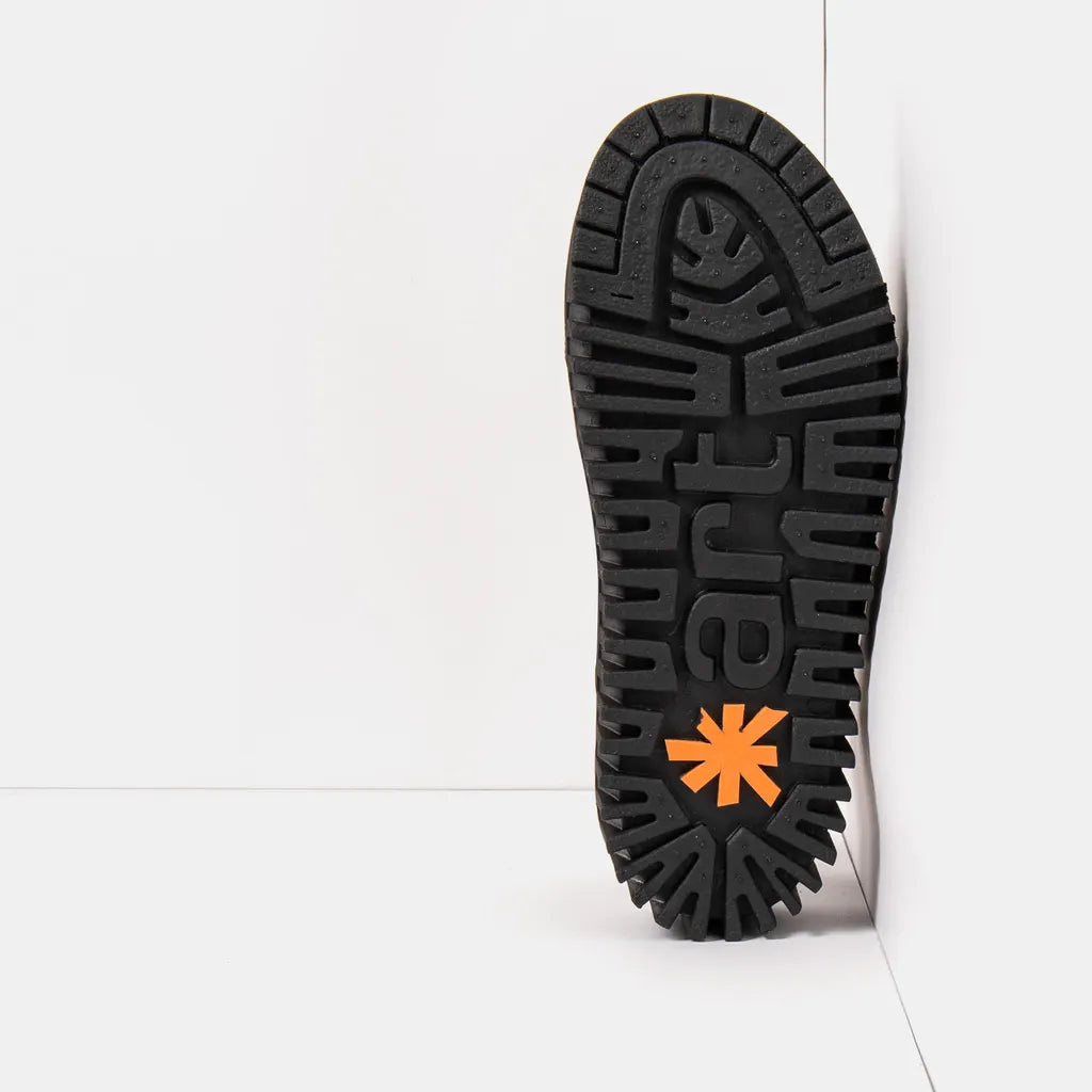 Close-up of a black sole with orange logo on a white background