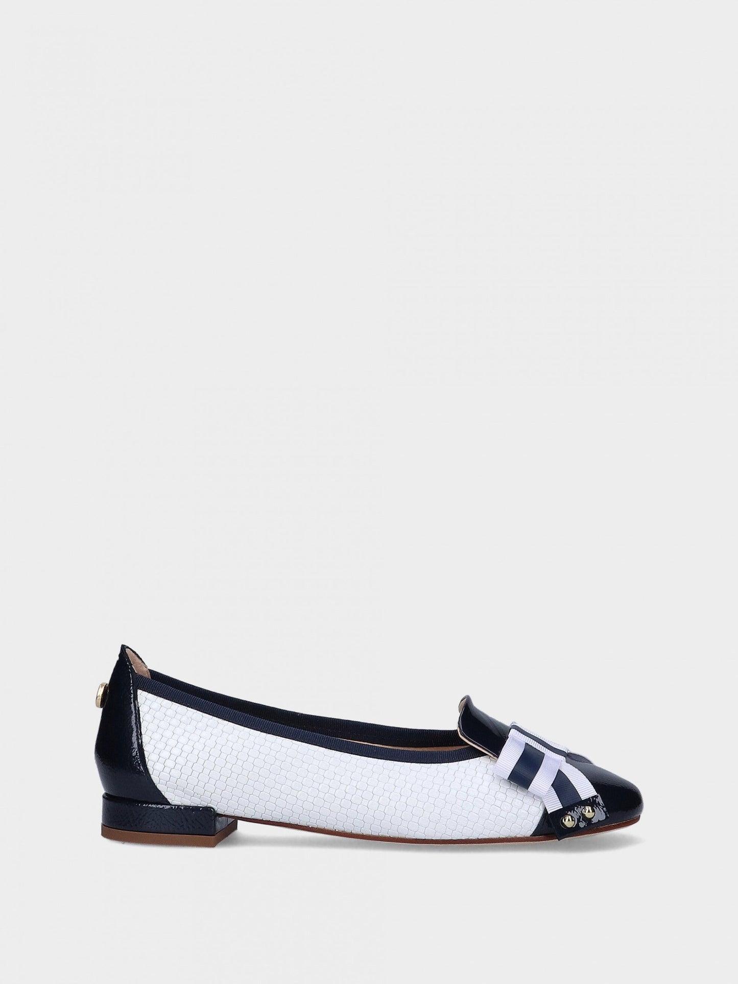 Navy and white flat shoe on a light gray background.  Available at Waterily Matticks.