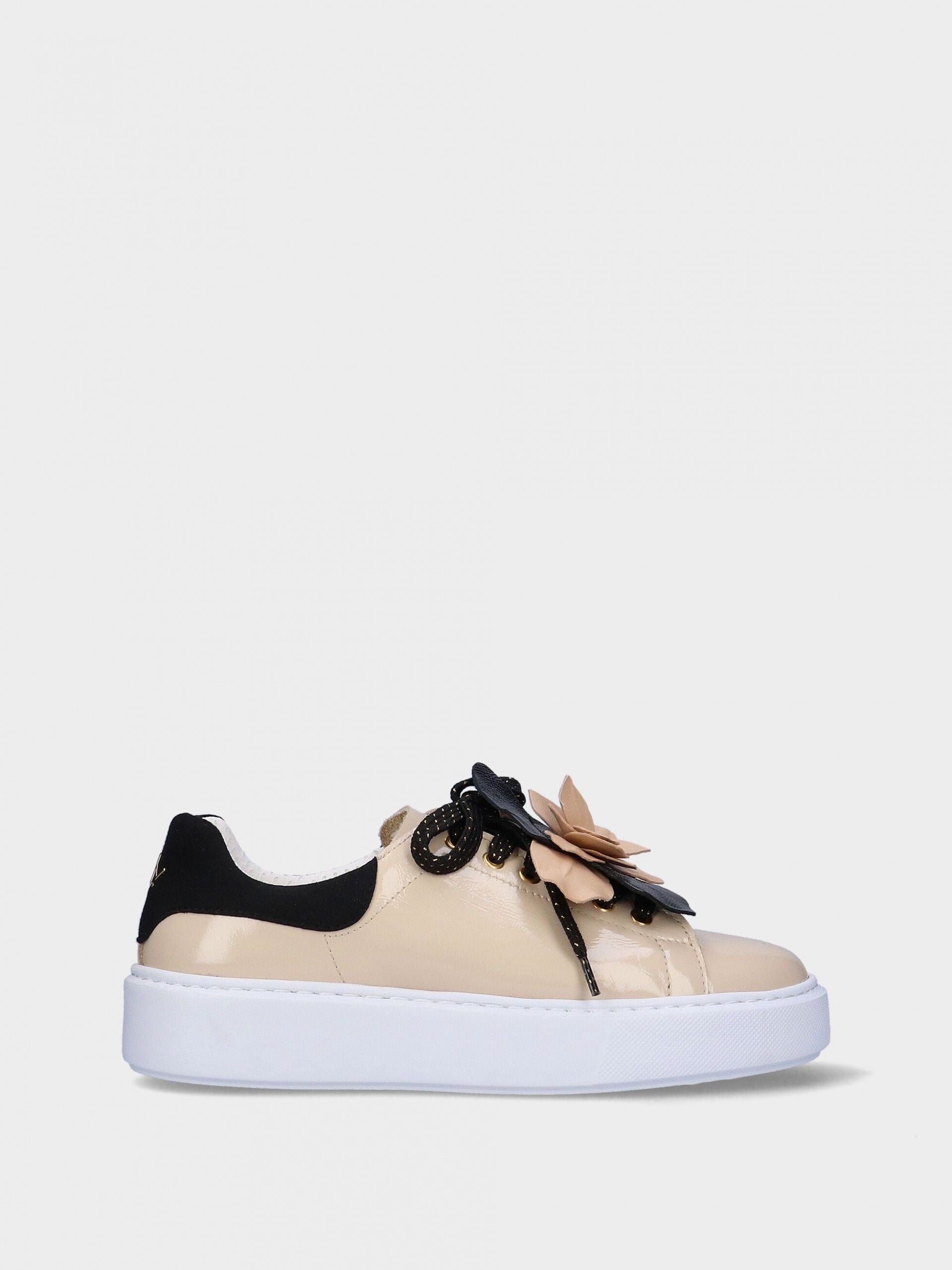 Beige sneaker with black accents and a floral detail on a white background