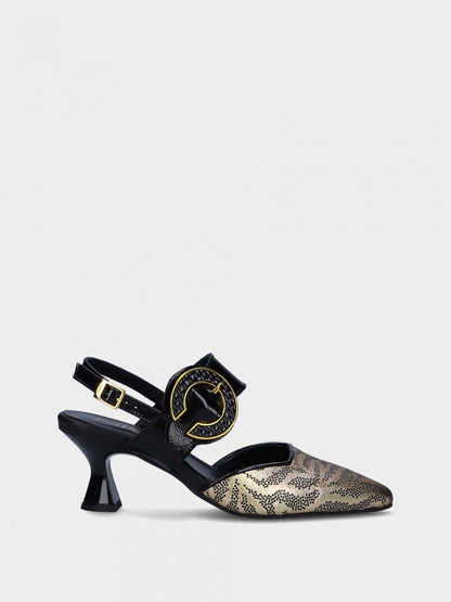 Gold and black high-heeled shoe with decorative buckle on a light gray background
