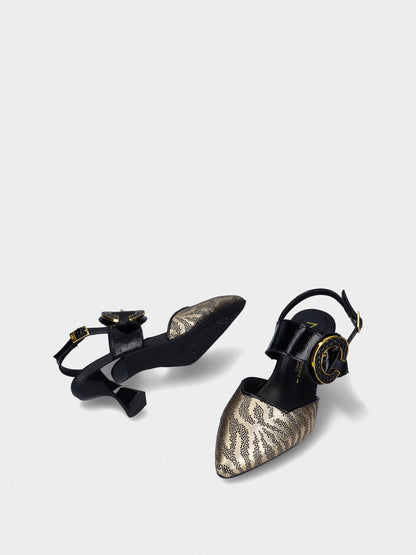 Pair of black and gold high-heeled shoes on a white background