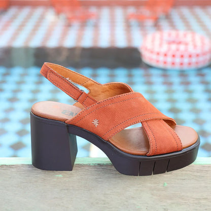 Dark Orange sandal with a block heel on a blurred background