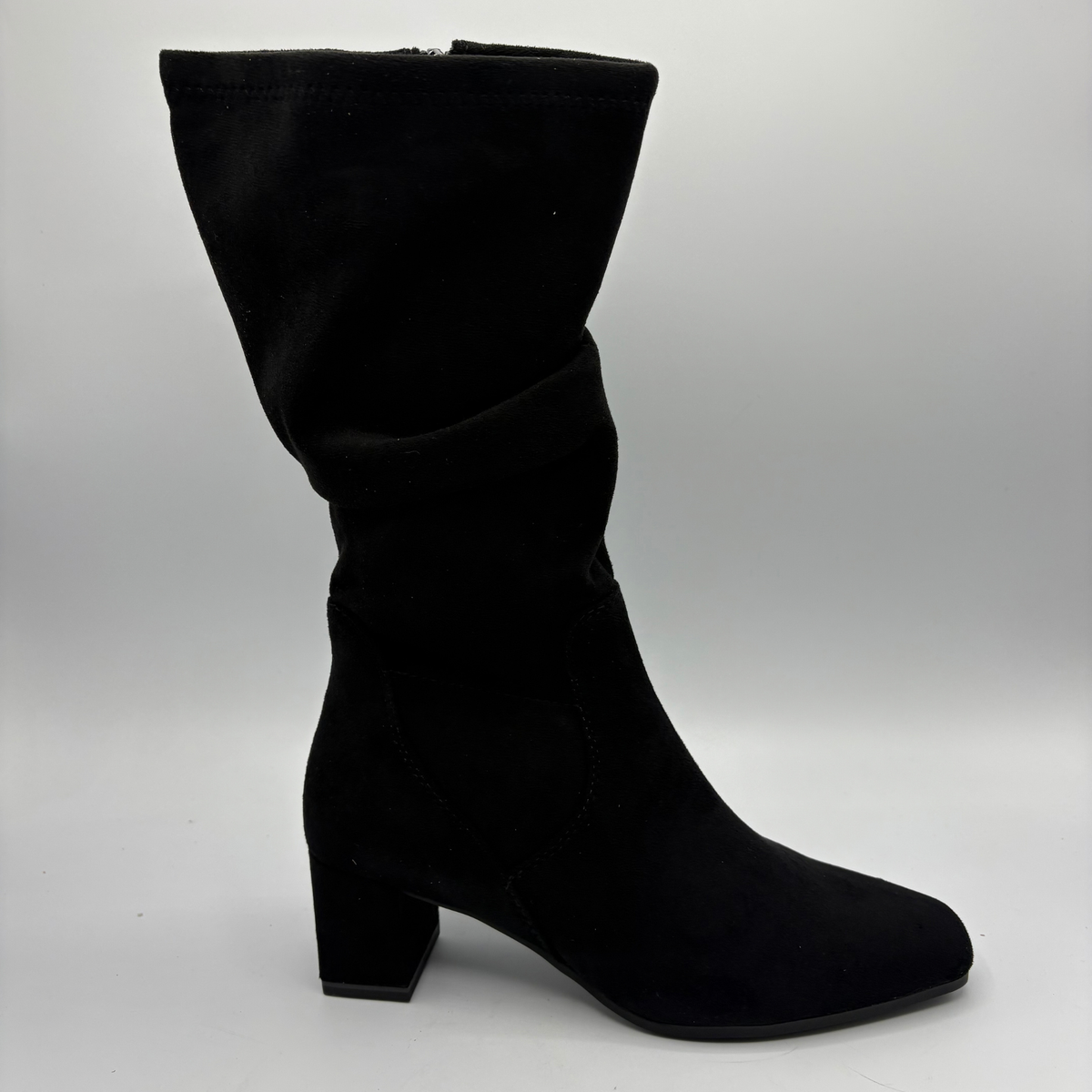 Right facing view of a black slouchy boot with a block heel