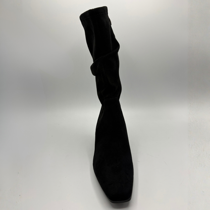 Front view of a black slouchy boot with a block heel