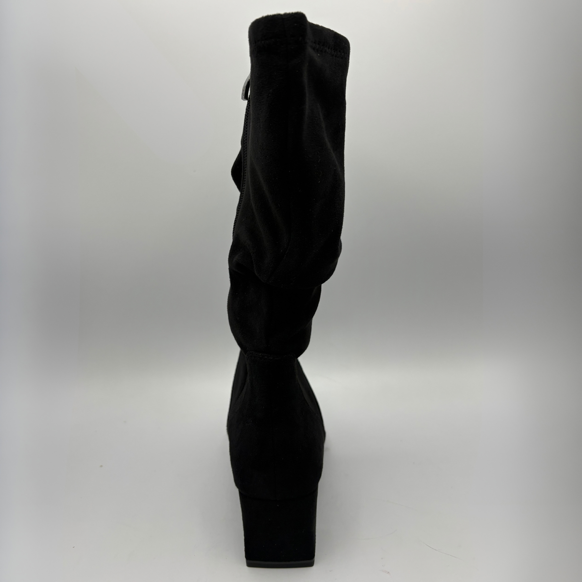 Back view of a black slouchy boot with a block heel