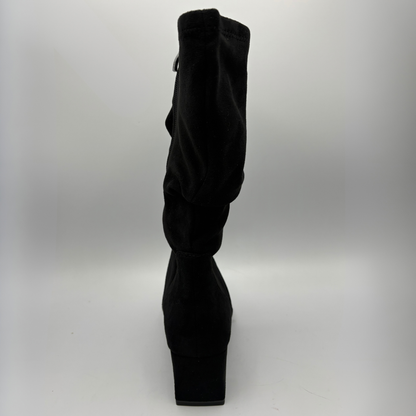 Back view of a black slouchy boot with a block heel