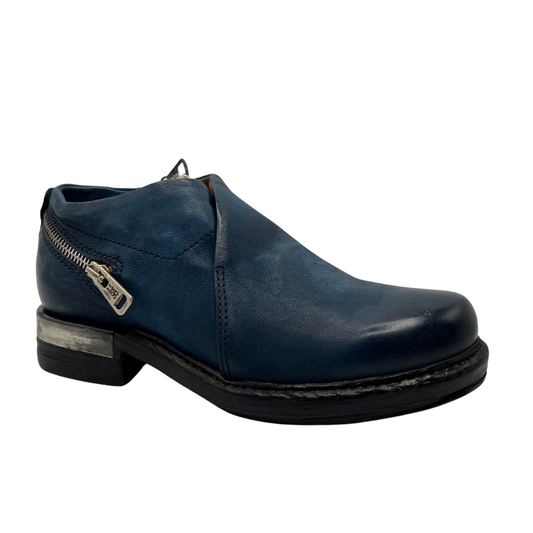 45 degree angled view of blue leather shoes with zipper heel accent and short heel