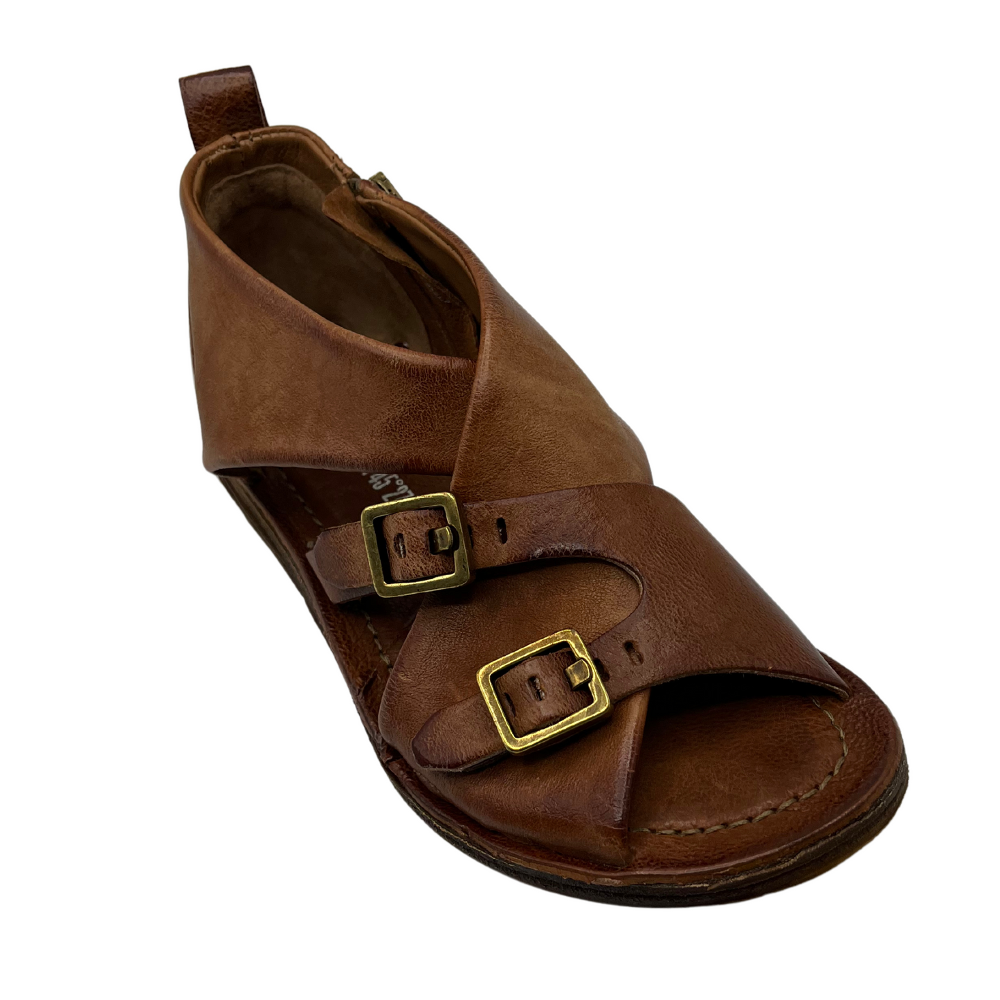 45 degree angled view brown leather flat with two gold buckle straps and leather lining