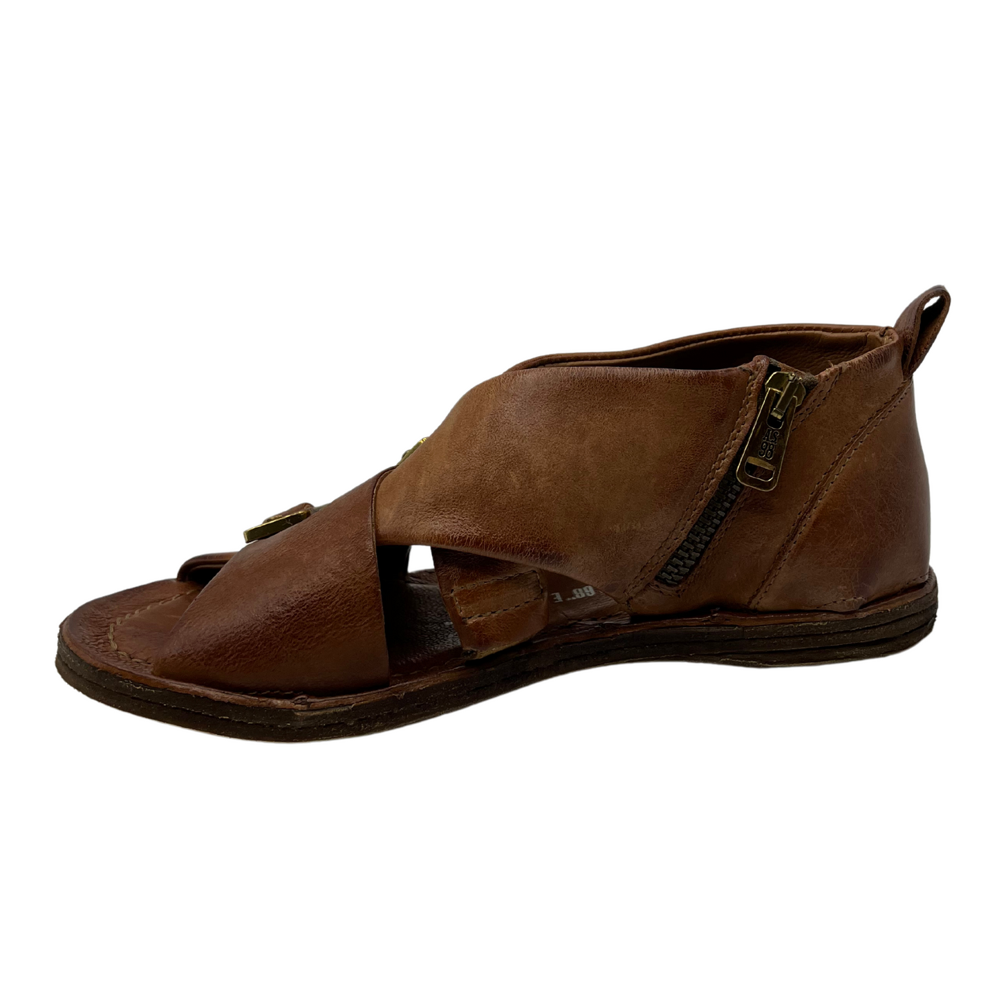 Left facing view of brown leather shoe with brass side zipper 