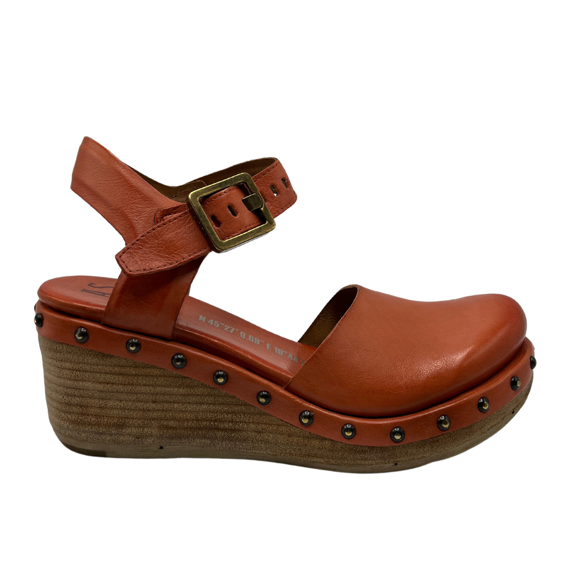 Right facing view of orange and tan wedge heel with closed toe and metal studs
