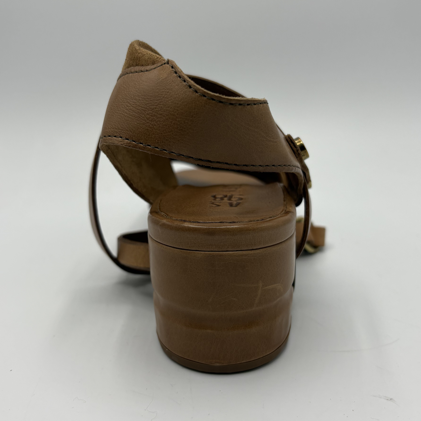 Brown sandal with a strap on a white background
