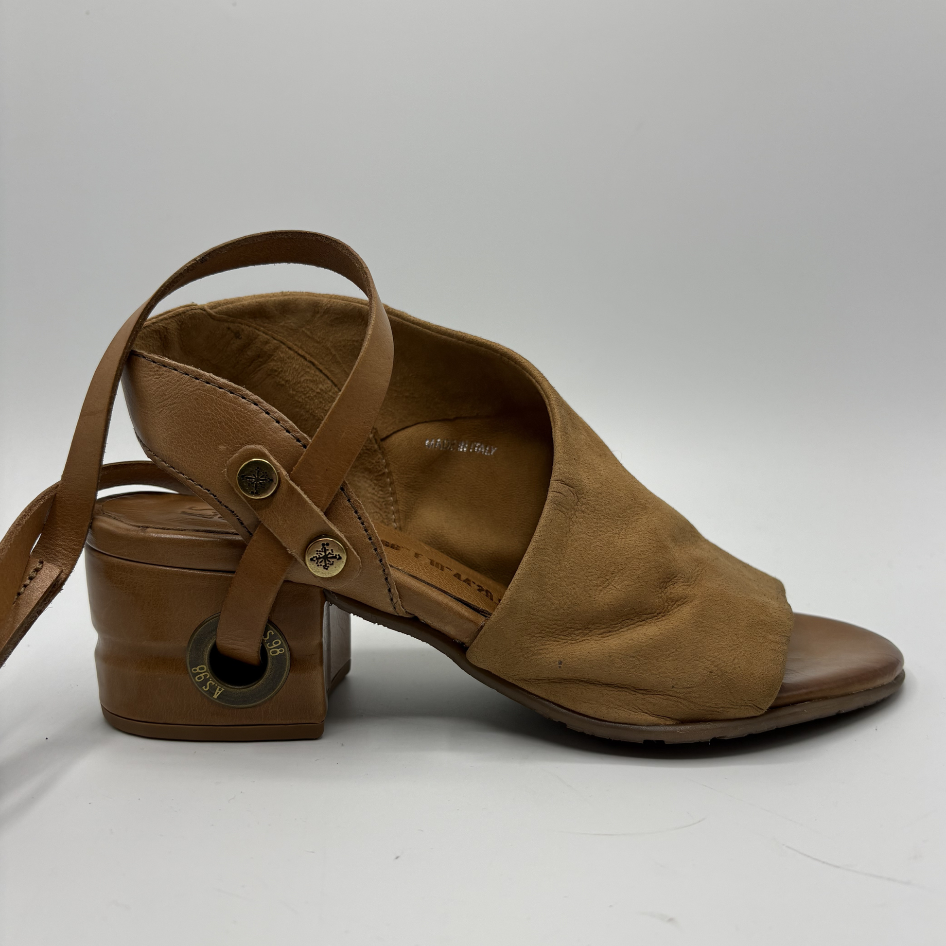 Brown sandal with strap on a white background
