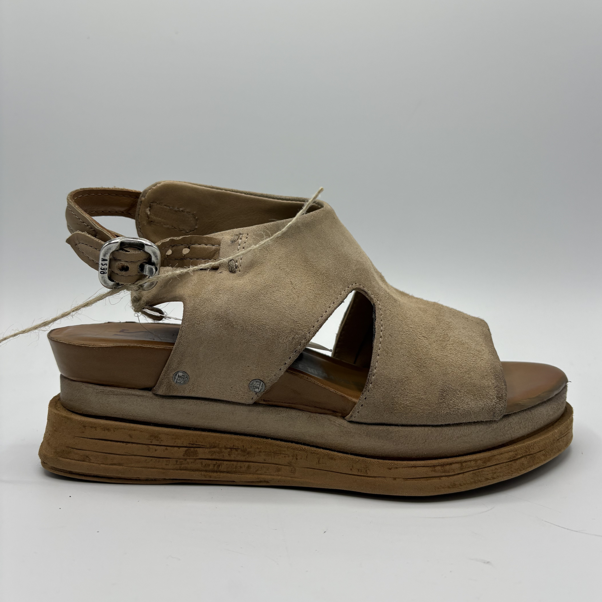 Brown sandal with a platform sole on a white background