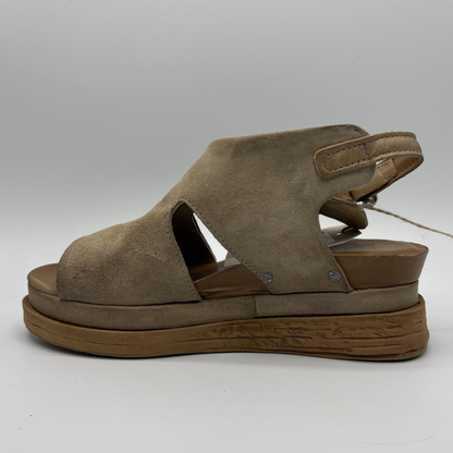 Brown sandal with platform sole on a white background