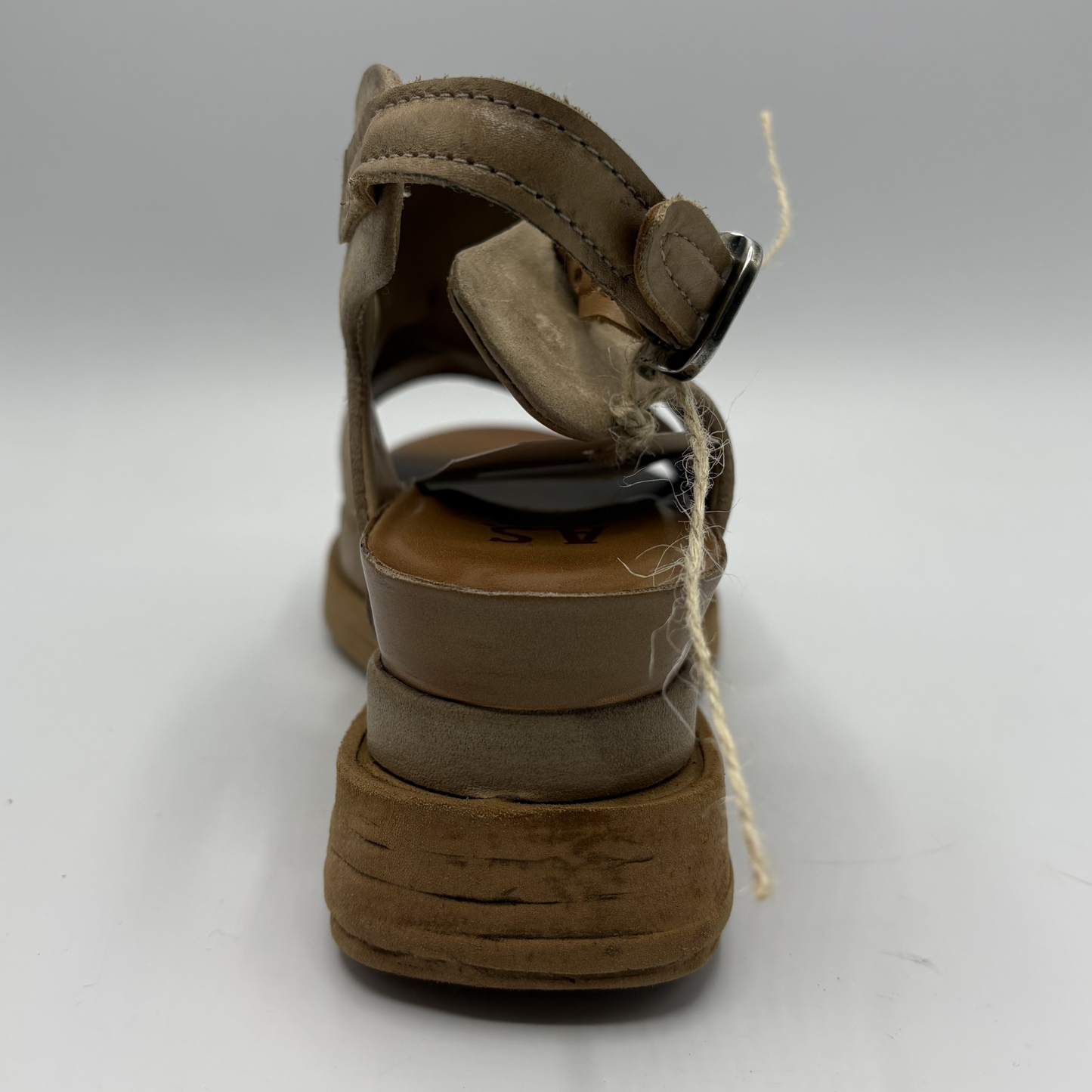 Brown sandal with a thick sole on a white background