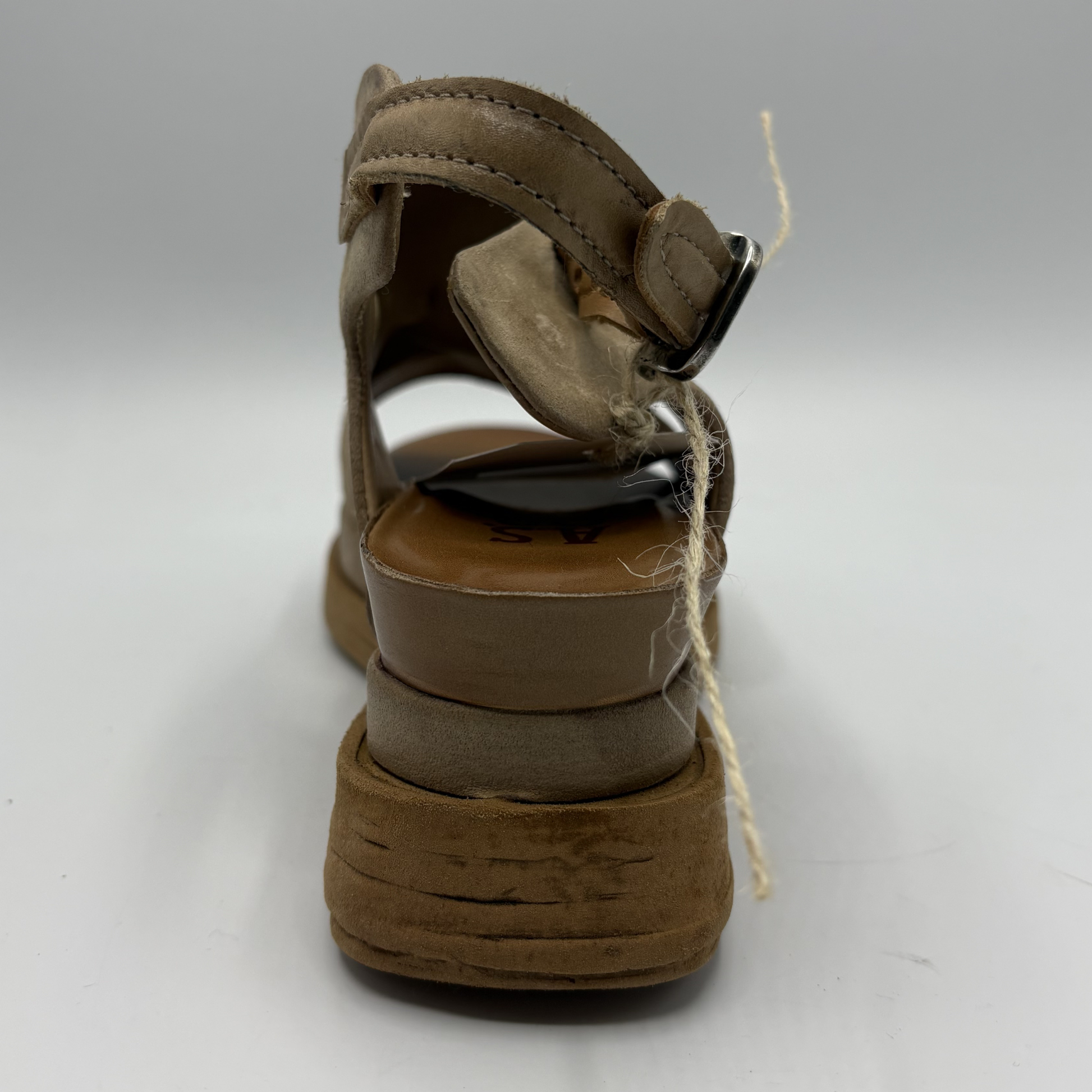Brown sandal with a thick sole on a white background