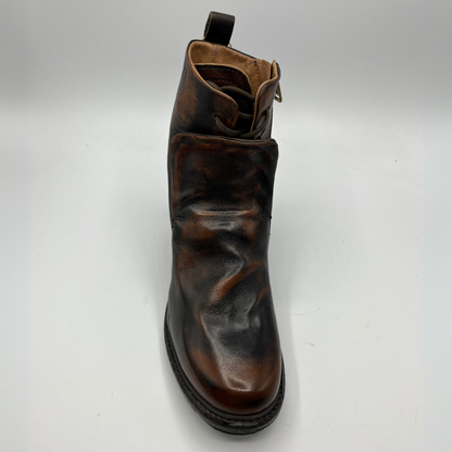 Top view of a brown and black burnished short boot with a gold accent on the heel and metallic embellishments along the shaft.