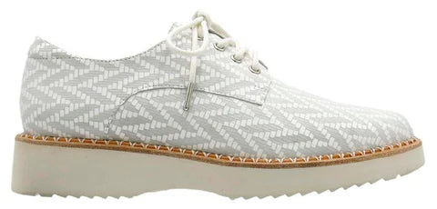 White patterned shoe with a brown sole on a white background