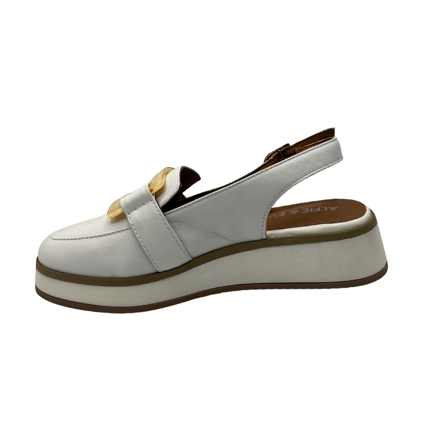 Left facing view of white leather slip on loafer with adjustable sling back strap, opaque square gold detail on upper and white wedge outsole.