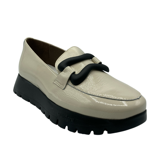 Angled view of platform leather loafer. Decorative buckle detail across the upper