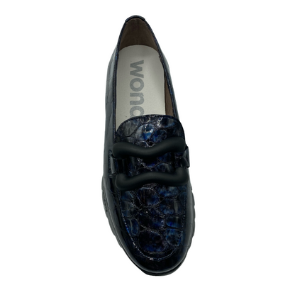 Top down view of blue/black leather loafer with black buckle detail