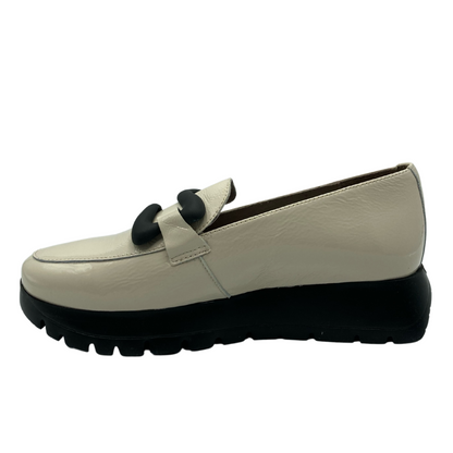 Inner side view of platform loafer with black buckle detail and black bottom