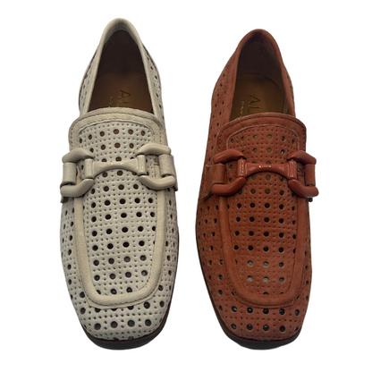 Top view of two perforated suede loafers beside each other. One is cream coloured and one is red brown. Both have a square toe and matching bit detail