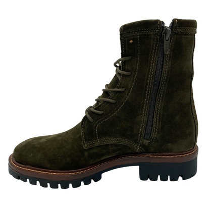 Left facing view of suede short boot with side zipper closure and black and brown rubber sole