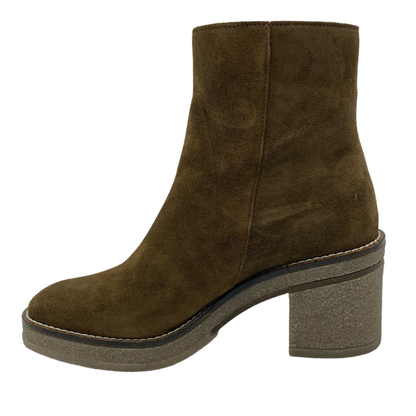 Left facing view of brown suede short boot with natural rubber sole and block heel