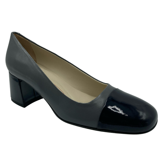 45 degree angled view of grey and navy leather block heel pump with leather lining
