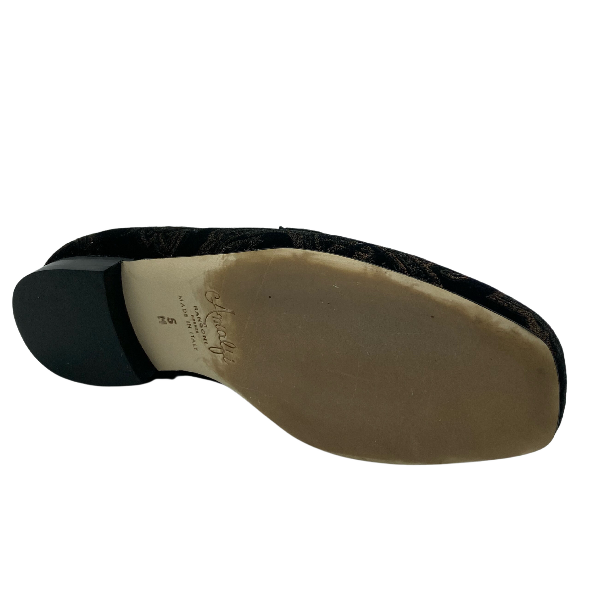 Bottom view of square toed loafer with short black heel