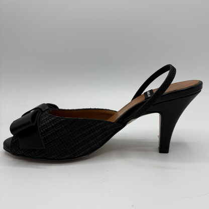 Black high-heeled shoe with a bow on a white background