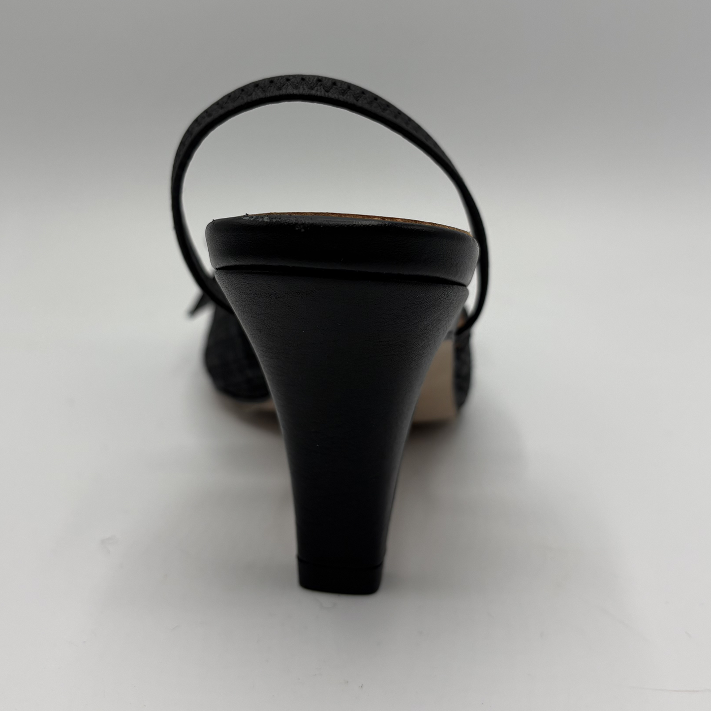 Black high-heeled sandal on a white background