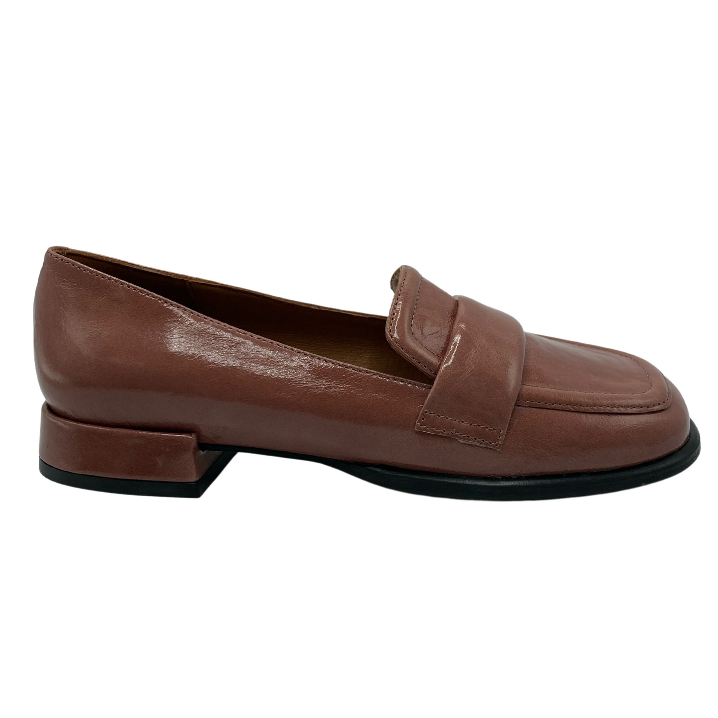 Right facing view of brown patent leather loafer with low heel and black outsole