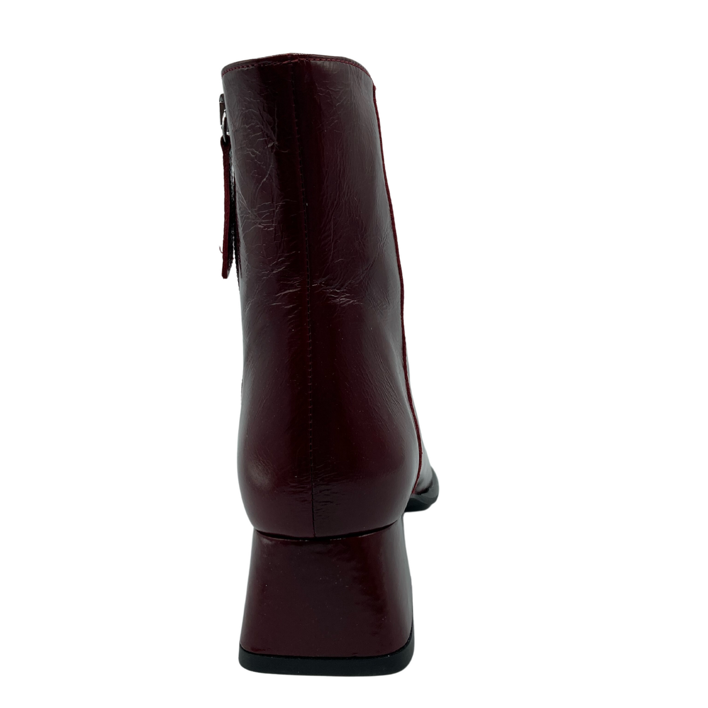 Back view of red leather short boot with flared heel and side zipper closure